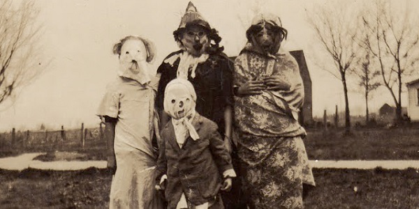 Old-fashioned Halloween masks, typical of their time. No teeth.