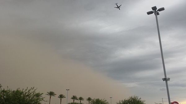 A wall of dust rolling in ahead of a thunderous rain.