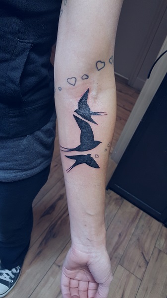 Three swallows in flight